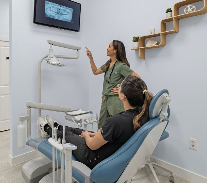 Brunette woman smiling after seeing her dentist in Pearland