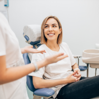 Woman smiling as she listens to her dentist